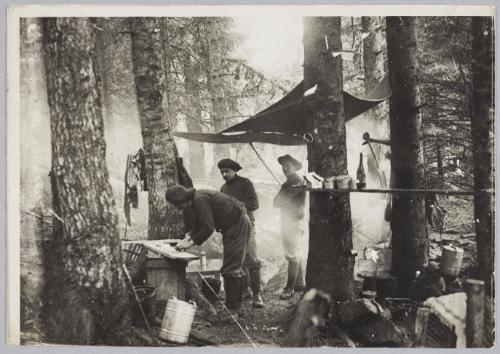 [soldiers preparing food in a forest]
