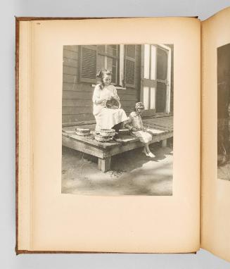 [Two habitant girls create baskets on their porch] Page 10 of The Abenaki; from collection of Canadian albums compiled by Edith S. Watson, 1890s-1930s