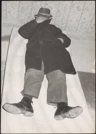 A man lies to rest on a mattress in shelter during the aftermath of an earthquake in Tuscany that left about 5,000 homeless