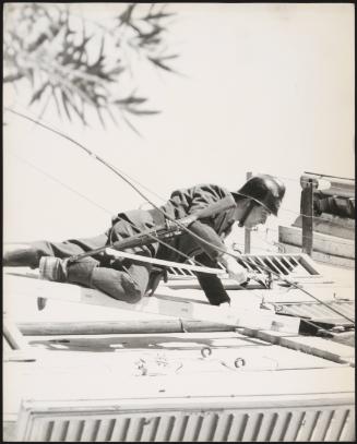 A policeman scales a building in the aftermath of the Fruili earthquake in 1976