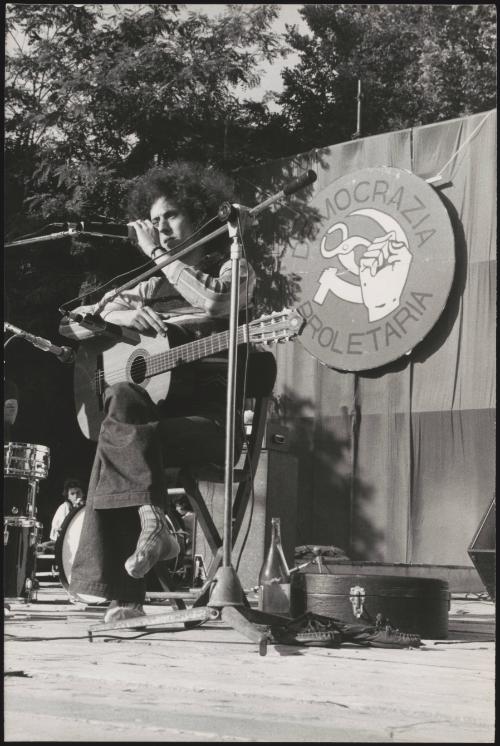 Folk rock singer Angelo Branduardi performs on an outdoor stage at a proletarian democracy event