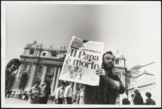 A man holds up a copy of a newspaper with the headline: 'The Pope is dead', in St. Peter's Square, after the death of Pope John Paul I on 28 September 1978