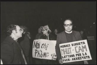Protesting priests are joined by Vietnamese and Buddists holding placards