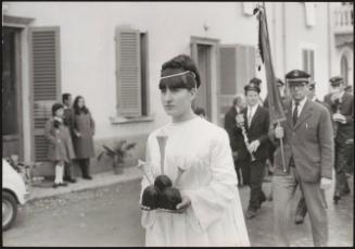 A young woman leads a religious procession 