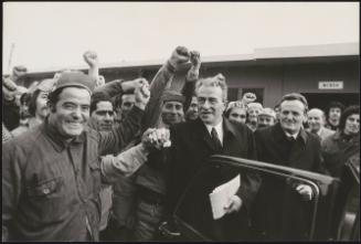 Pietro Ingrao stands surrounded by many cheering supporters 