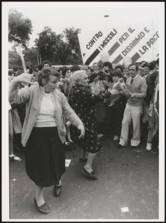 Two women dance at an anti-nuclear-missile protest march