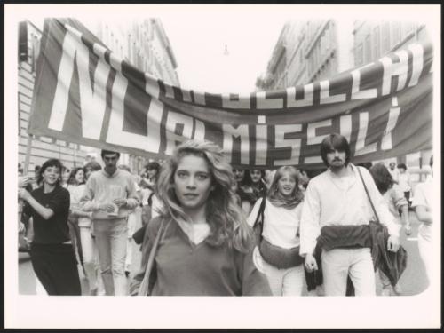 A young woman leading a group at an anti-nuclear march
