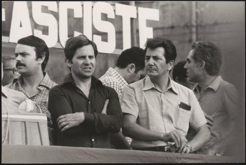 A small crowd of men attend an Anti Fascist rally