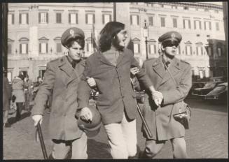 A protester escorted away by policemen