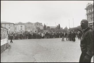 A large crowd of protesters line up in front of a metro station, Rome
