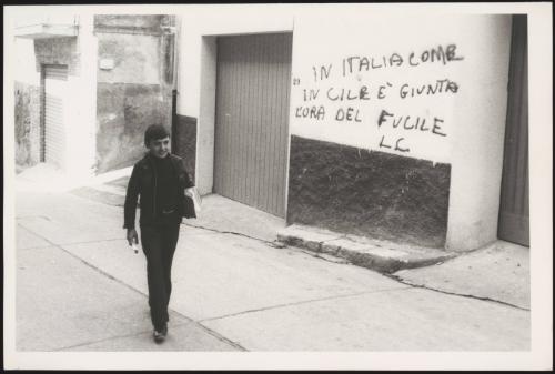 A young boy walks in a street in Matera, Italy