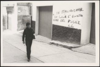 A young boy walks in a street in Matera, Italy