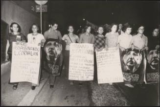Protesters carrying placards with messages of solidarity with Chile and Luis Corvalan, the general secretary of the Communist Party of Chile