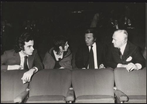 The actor and director Vittorio De Sica sitting in a cinema with his son Christian (far left) 