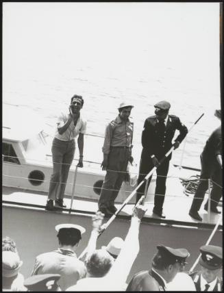 Police on a boat at the port of Filicudi