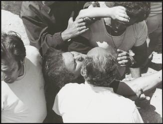 Some men help a woman who has fainted during the Filicudi protests against the Mafia, 1971