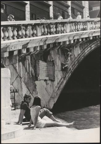 An Italian 'Pappagalli' man and a female tourist, Venice