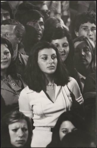 A young Romani woman in a crowd