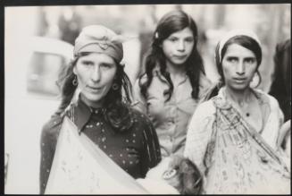 Romani women carrying their children