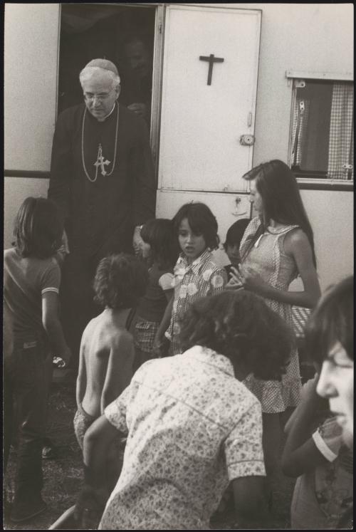 Monsignor Emanunele Clarizio arrives to meet a nomad Romani group at their caravan