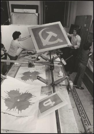 Communist party supporters screen printing posters 