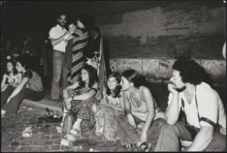 Adults and children waiting on steps and pavements for the announcement of election results