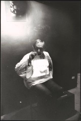 Portrait of Hungarian director Miklós Jancsó on a cigarette break on set