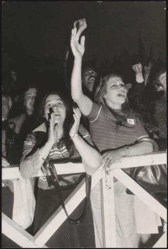 A young crowd cheers and claps as they get ready to meet politician Enrico Berlinguer