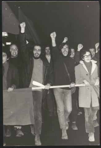 Angry protesters carrying poles and flags during a demonstration march