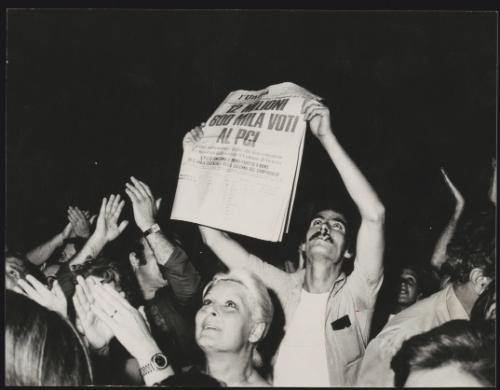 A man holds up a copy of 'L'Unita' whose headline reads - '12 million 600 thousand votes to PCI', dated 23rd June 1976