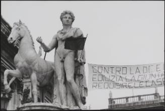 The ancient statue of Castor on the Piazza del Campidoglio in Rome holds one end of a protest banner