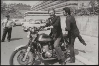 Actor Federico Martignoni with club owner Paolo Vassallo on a motorbike during the Number One night club drugs scandal

