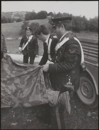 Policemen deal with the aftermath of a gun battle with neo-fascists on L ' Rascino Plateau in which right-wing extremist Giancarlo Esposti was shot dead