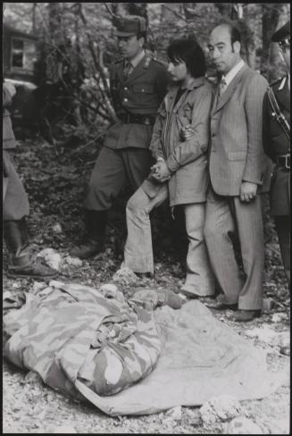 Policemen deal with the aftermath of a gun battle with neo-fascists on L ' Rascino Plateau in which right-wing extremist Giancarlo Esposti was shot dead