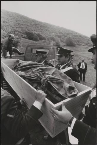 Policemen deal with the aftermath of a gun battle with neo-fascists on L ' Rascino Plateau in which right-wing extremist Giancarlo Esposti was shot dead
