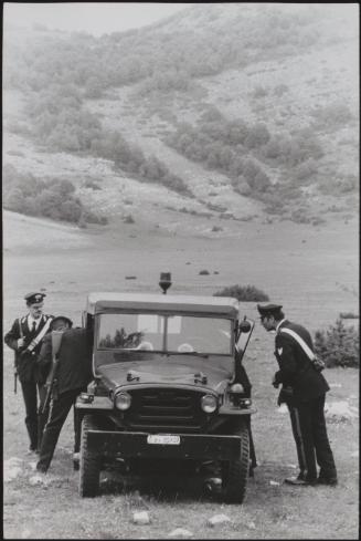 Policemen deal with the aftermath of a gun battle with neo-fascists on L ' Rascino Plateau in which right-wing extremist Giancarlo Esposti was shot dead