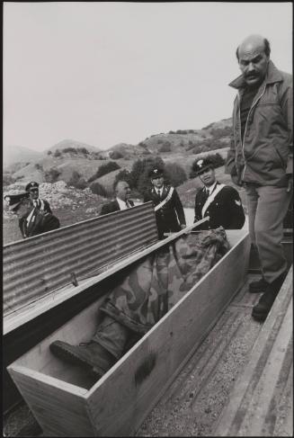 Policemen deal with the aftermath of a gun battle with neo-fascists on L ' Rascino Plateau in which right-wing extremist Giancarlo Esposti was shot dead