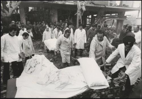Stretchers are carried from a destroyed building in the aftermath of an explosion 