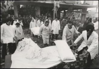Stretchers are carried from a destroyed building in the aftermath of an explosion 