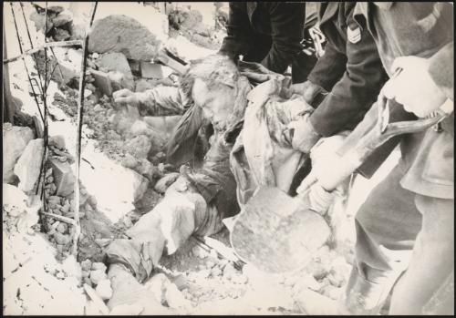 A body trapped is pulled the rubble after buildings collapsed due to the earthquake in Belice, Sicily, which measured 6.4 on the Richter scale