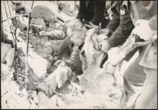 A body trapped is pulled the rubble after buildings collapsed due to the earthquake in Belice, Sicily, which measured 6.4 on the Richter scale