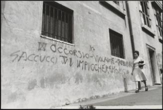 Graffiti on a street wall with a political message against the magistrates who investigated neo-fascist criminal activities (and naming also one of the leaders of the neo-fascists, Saccucci)