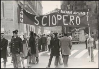 Trade union members gather in the street to protest, including the nuclear technicians union