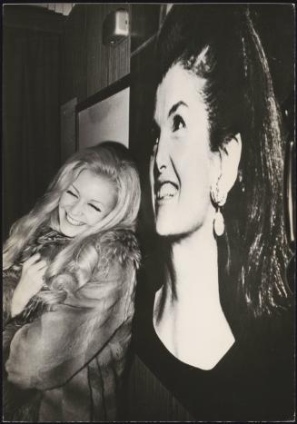 Italian singer Patty Pravo with a large photograph of Jackie Kennedy