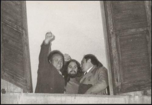 Rome, Dec 29, 1972. Pietro Valpreda and fellow anarchist Robert Garganelli raise clenched fists from a window of their hospital to acknowledge news from supporters a few minutes after he had been freed pending trial. At right his lawyer Guido Calvi