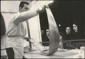 View from inside a street food kiosk in Piazza Navona, Rome. People line up outside.