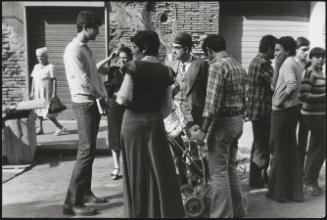 Young men, women, children and adults congregate on the streets in Rome where the Jewish Ghetto once stood