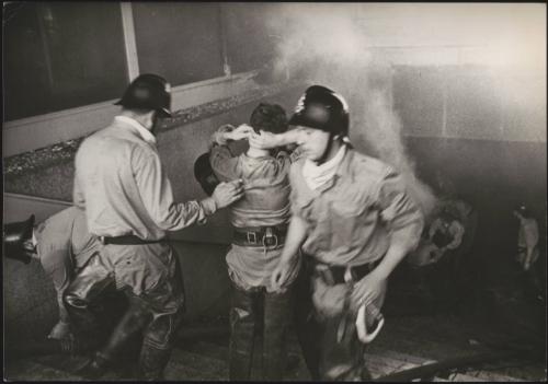 Firefighters around a staircase putting out a blaze after the Belice earthquake, 1968, Sicily