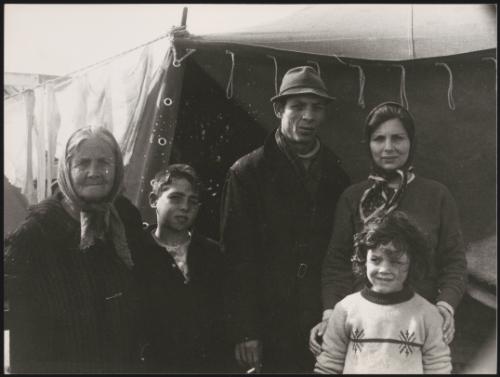 A family stand in front of temporary shelter in the aftermath of the Belice earthquake in Sicily 1968