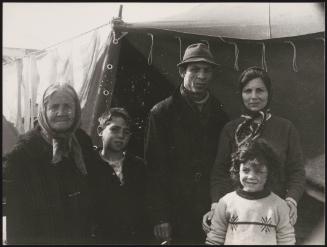 A family stand in front of temporary shelter in the aftermath of the Belice earthquake in Sicily 1968